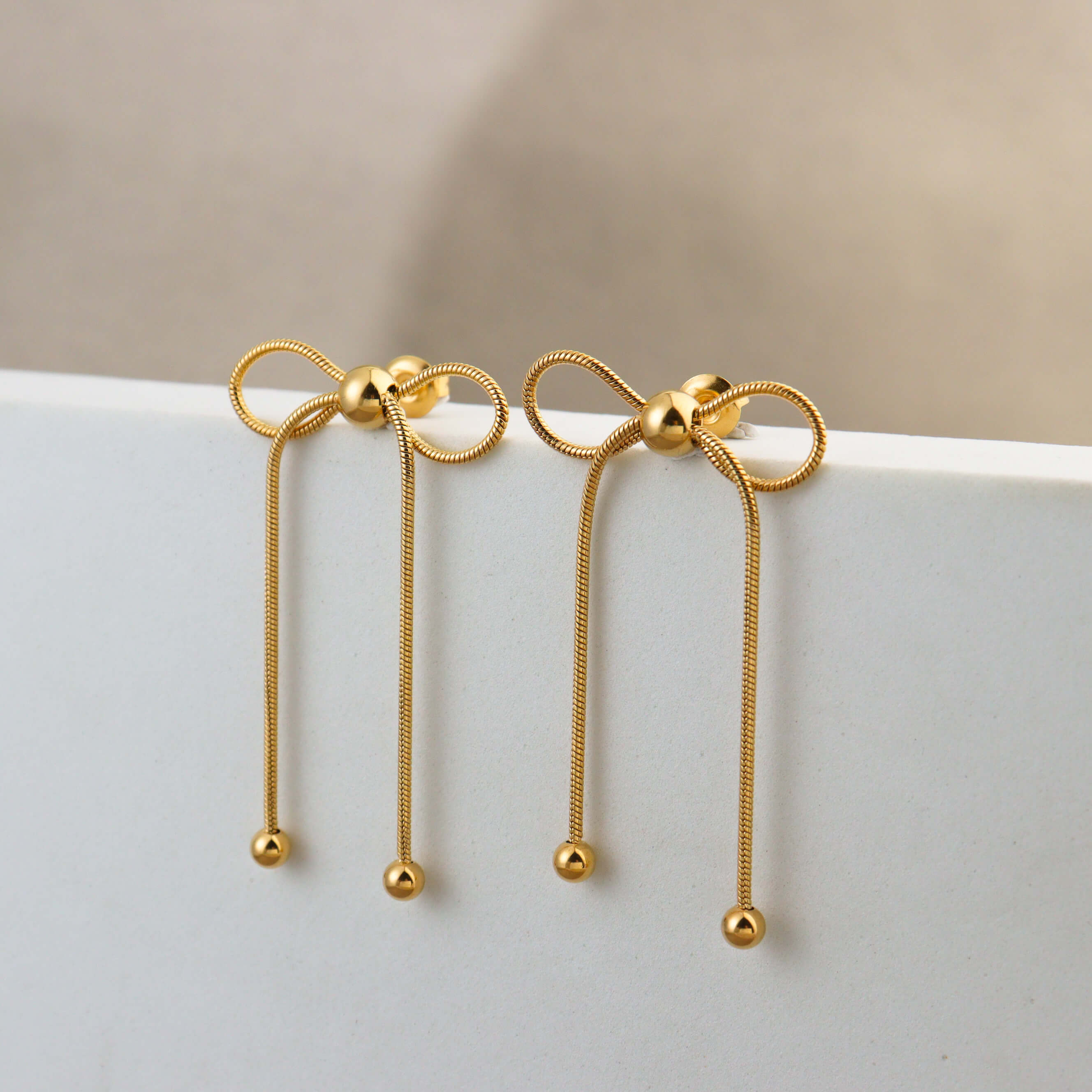 Dancing Bow Gold Earrings