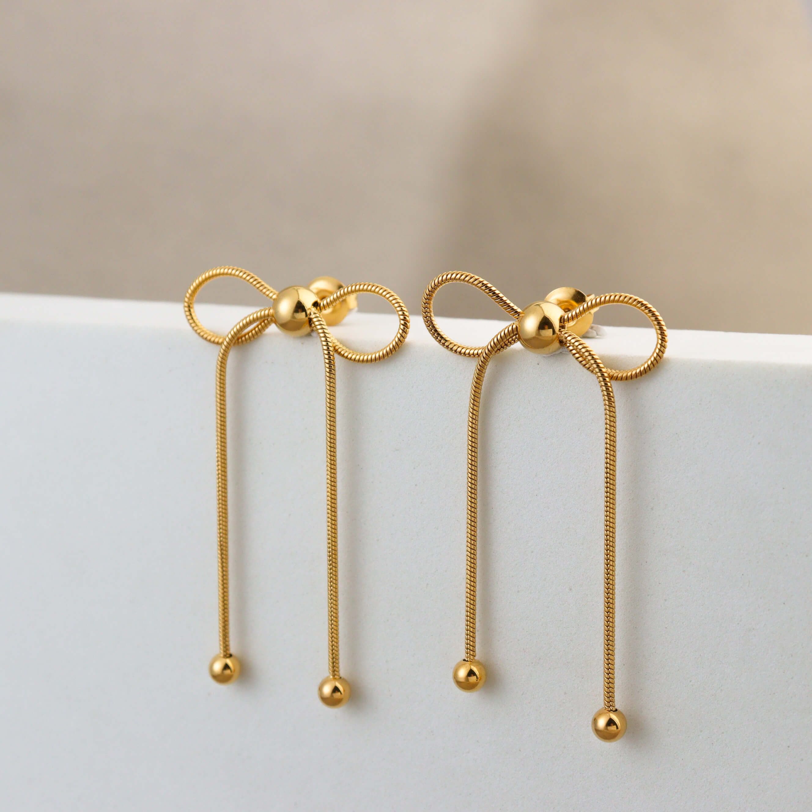 Dancing Bow Gold Earrings