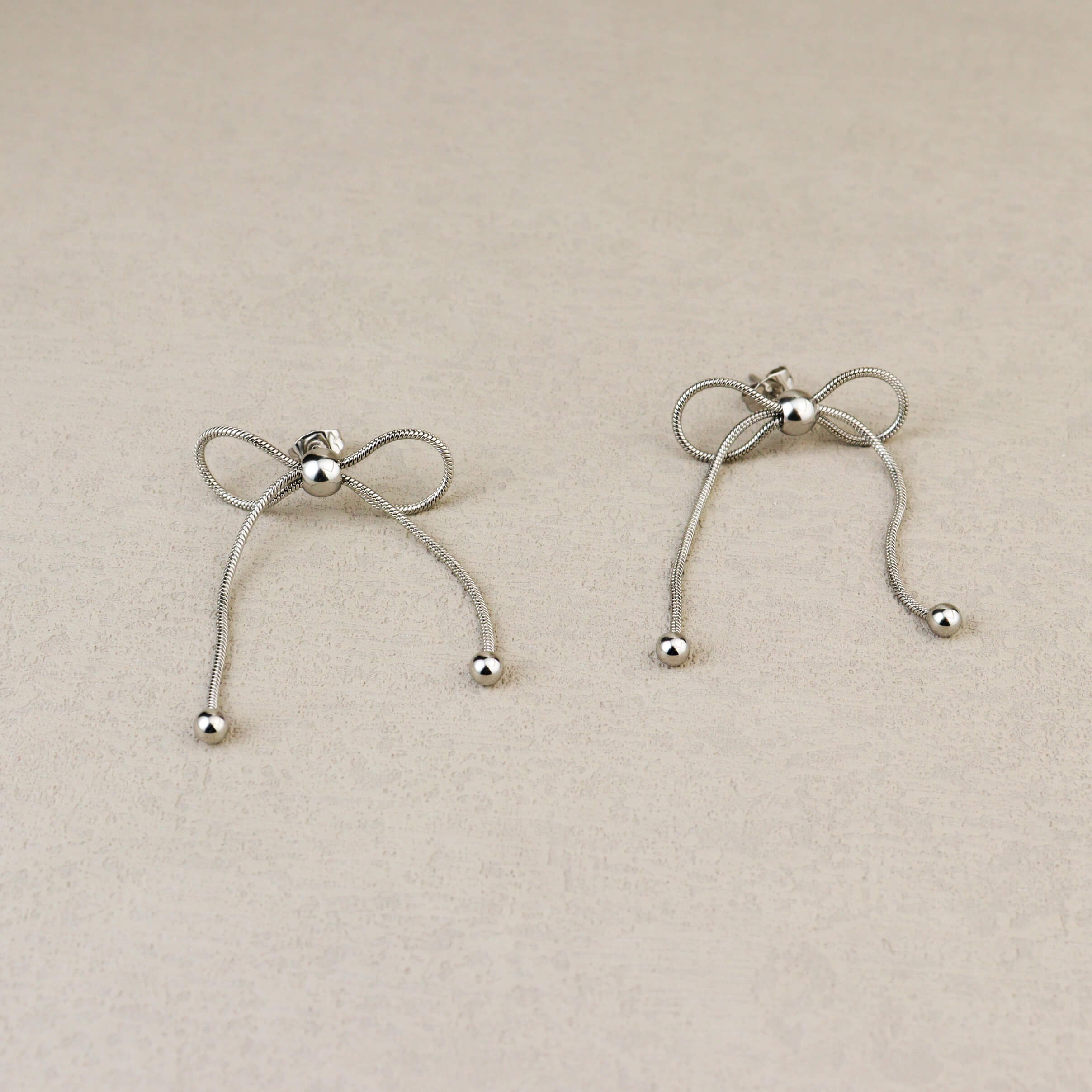 Dancing Bow Silver Earrings