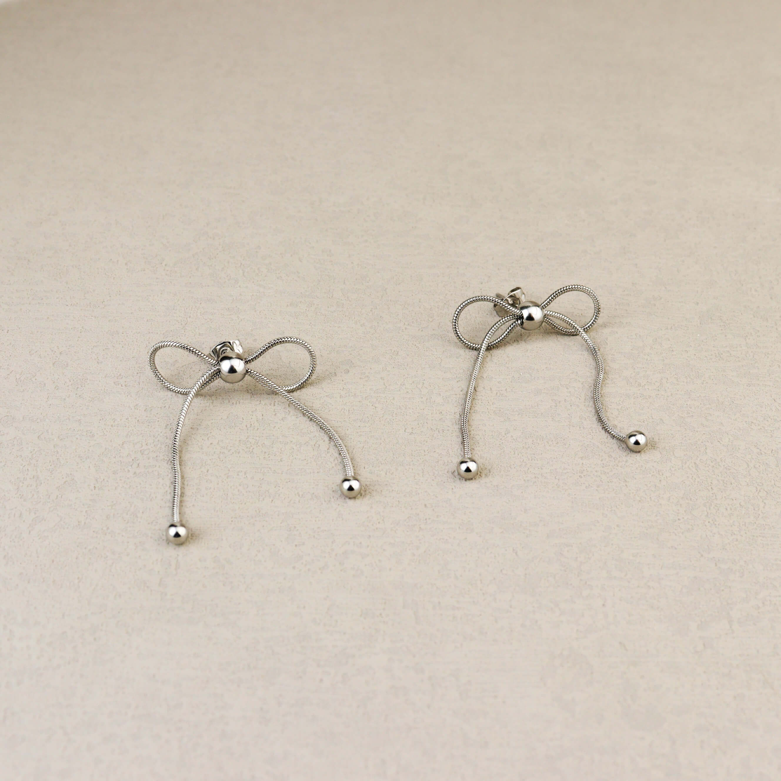 Dancing Bow Silver Earrings