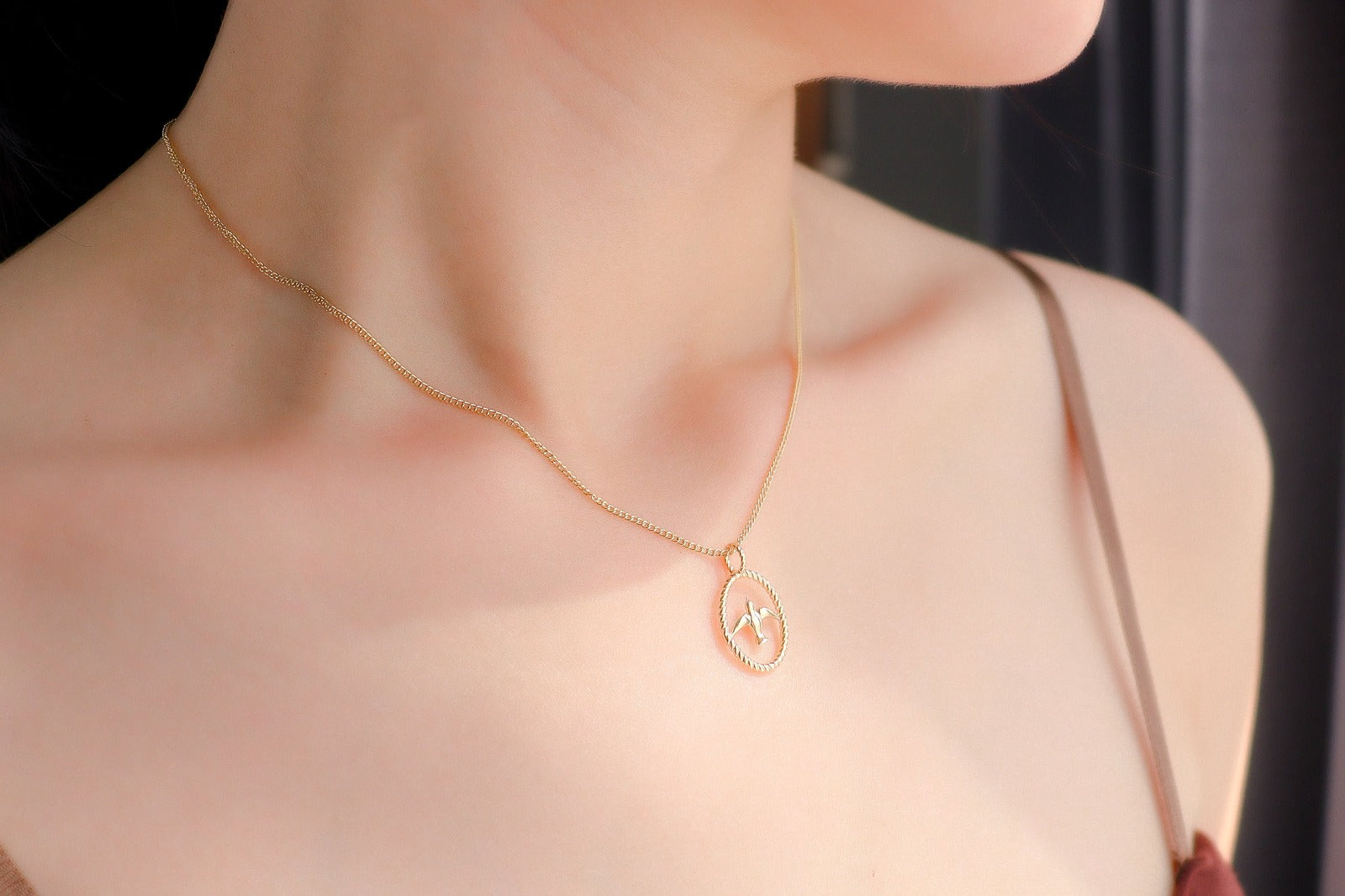 gold necklace with swallow bird