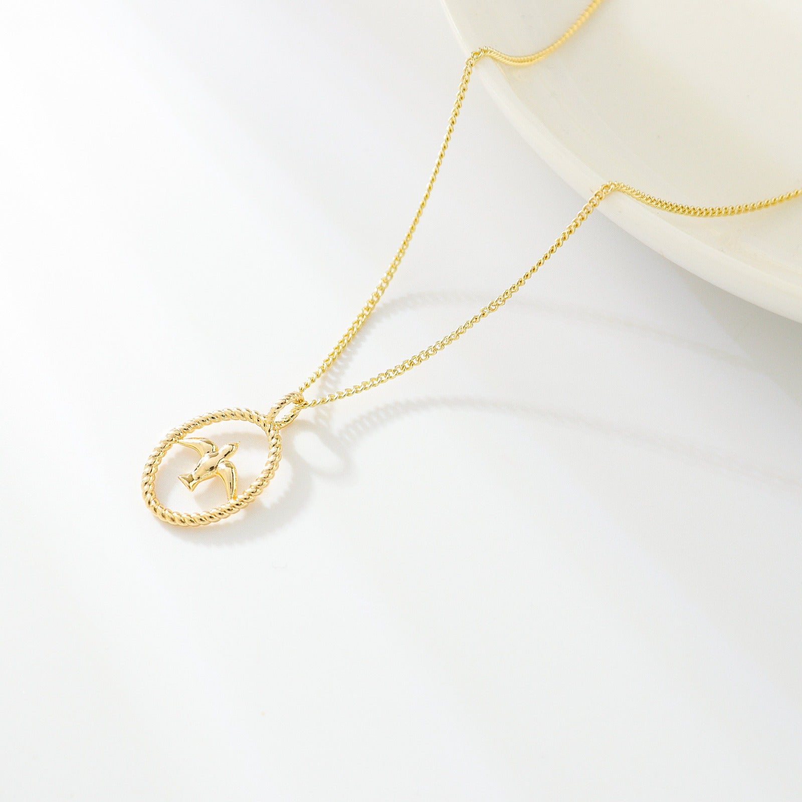 gold necklace with swallow bird