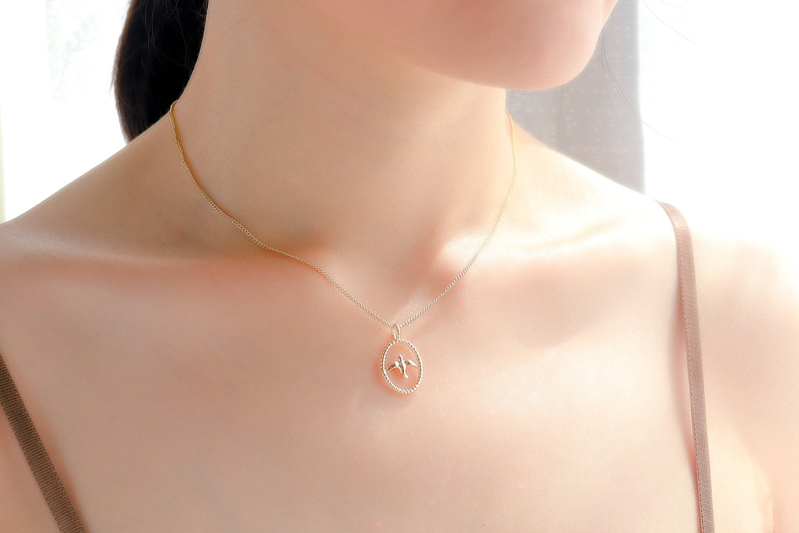 gold necklace with swallow bird